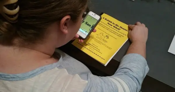 Debra Dollar ONH patient using Iphone to assist her reading