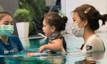 Young child with Spina Bifida swimming